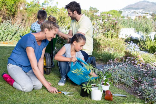 Crew placing separated green waste into labelled containers at a garden